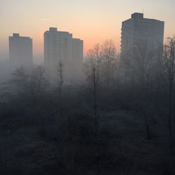 Silhouette buildings against sky during sunset