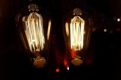 Close-up of illuminated light bulbs in darkroom