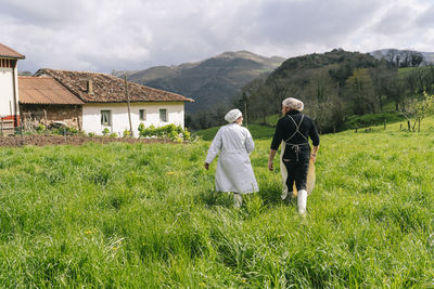 Male and female entrepreneurs walking on grass