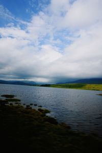 View of calm sea against cloudy sky