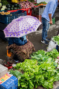 Low section of woman standing on display at market
