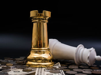 Close-up of bottles on table against black background