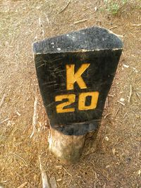 High angle view of arrow sign on field