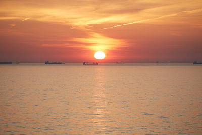 Scenic view of sea against romantic sky at sunset