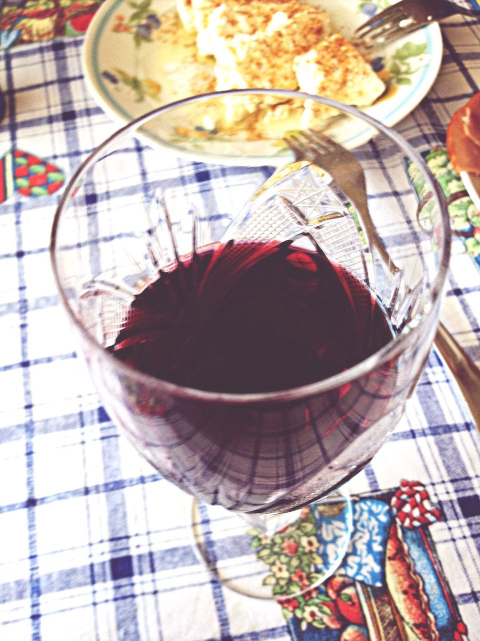 indoors, table, glass - material, food and drink, still life, reflection, high angle view, freshness, drink, glass, transparent, directly above, tablecloth, pattern, no people, close-up, plate, decoration, multi colored, drinking glass