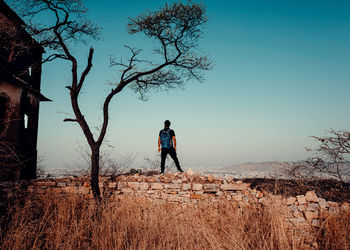 Full length of man standing on field against sky