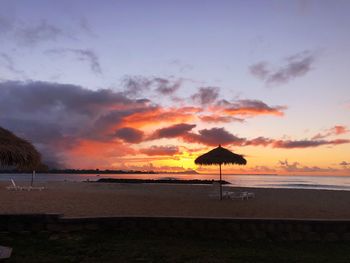 Scenic view of beach against sky during sunset