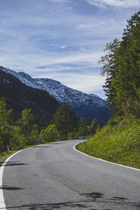 Road by mountain against sky