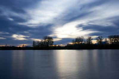 Scenic view of lake against sky during sunset