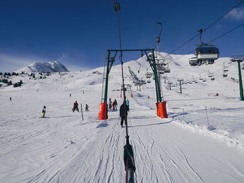 People skiing on snow covered field