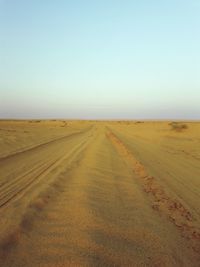 Empty road along countryside landscape