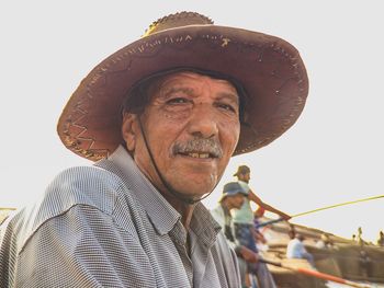 Portrait of man wearing hat against sky