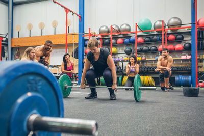 Full length of woman weightlifting at gym