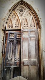 Low angle view of closed door of old building