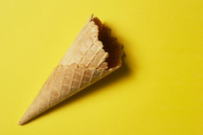 Close-up of ice cream over yellow background