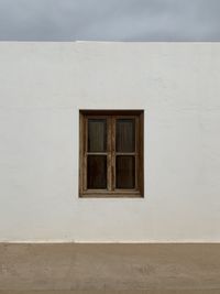 Low angle view of window on white wall of building