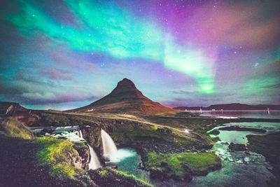 Scenic view of landscape against sky at night