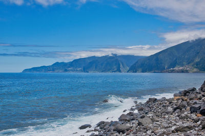 Scenic view of sea against blue sky