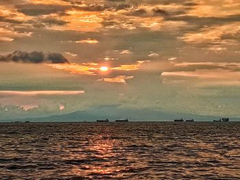 Scenic view of sea against sky at sunset