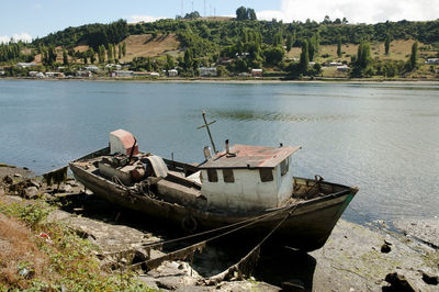 Abandoned boats moored on shore