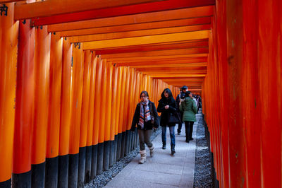 People walking in corridor of temple