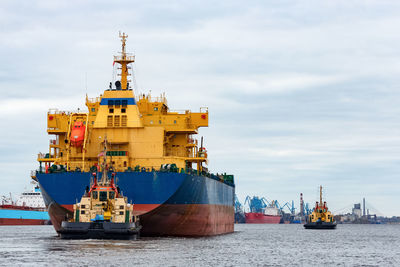 Commercial dock by sea against sky