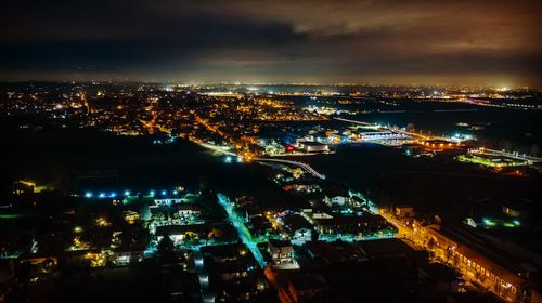 High angle view of illuminated buildings in city at night