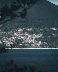 Aerial view of city buildings by sea