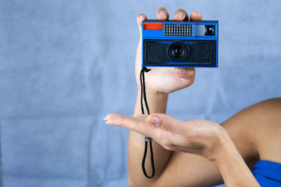 Cropped hand of man holding equipment