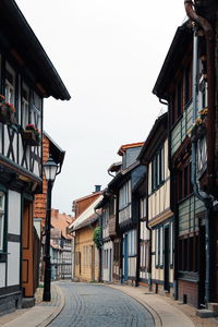 Street amidst buildings against sky