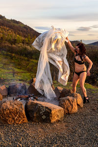 Woman celebrating divorce by burning her wedding dress