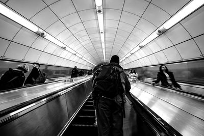 Rear view of people on escalator