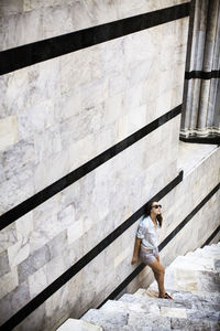 Low angle view of man sitting on steps