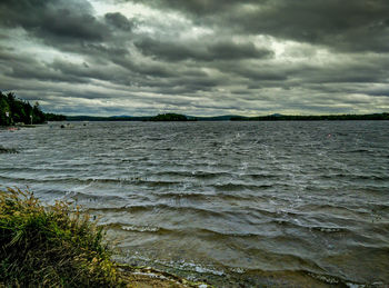 Scenic view of sea against cloudy sky