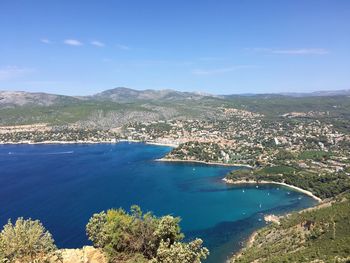 High angle view of sea and cityscape against sky