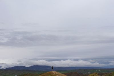 Scenic view of landscape against cloudy sky