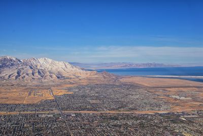 Scenic view of landscape and mountains against blue sky