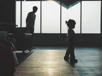 Silhouette men standing in corridor