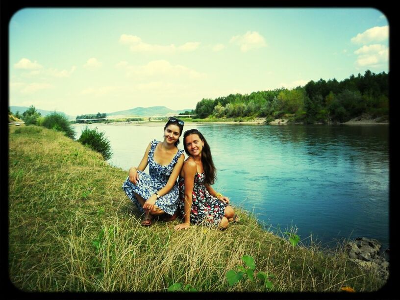 water, lifestyles, leisure activity, sky, person, young adult, lake, casual clothing, transfer print, young women, auto post production filter, portrait, looking at camera, tranquility, full length, nature, standing, smiling