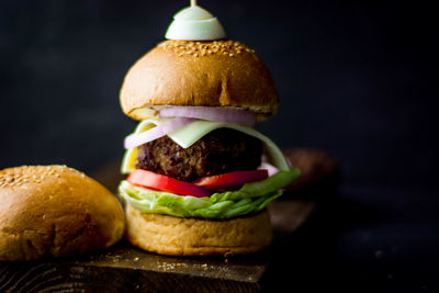 Close-up of bread with ice cream against black background