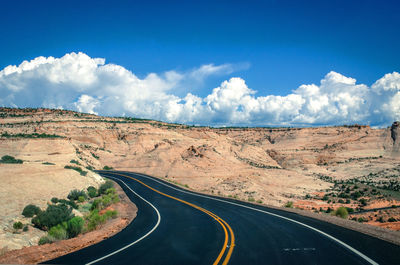 Panoramic view of road amidst landscape against sky