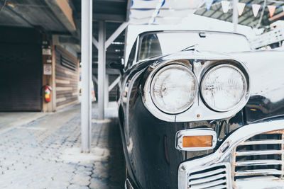 Close-up of vintage car on street