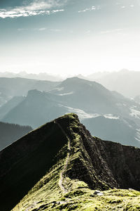 Aerial view of mountain range against cloudy sky