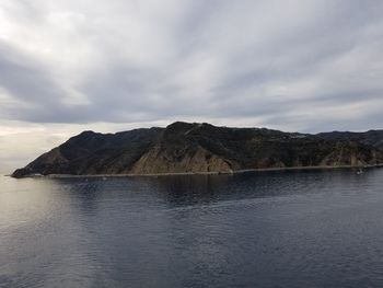 Scenic view of sea and mountains against sky