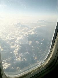 Cropped image of airplane wing over landscape