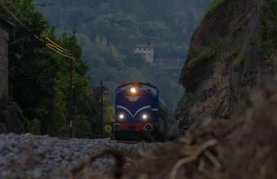 Train on railroad track by mountains