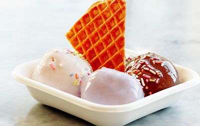 Close-up of ice cream with waffle in container on table