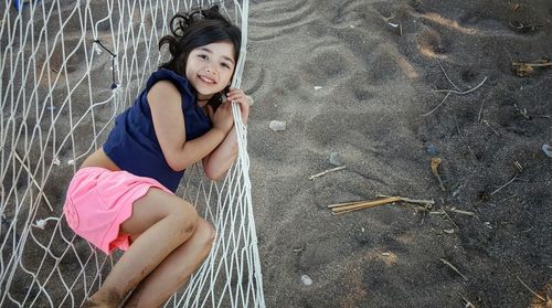 Directly above portrait of girl relaxing on hammock