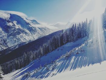 Scenic view of snow covered mountains against sky