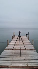 Pier over sea against sky